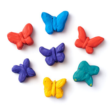Colorful handmade play-doh butterflies collection on white background