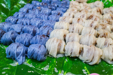 Thai steamed rice skin dumplings khao kriap pak mor with butterfly pea. Translucent blue dough and coconut cream. Authentic appetizer for Asian menus and gourmet lifestyle media. © The Dell Shot by SJ