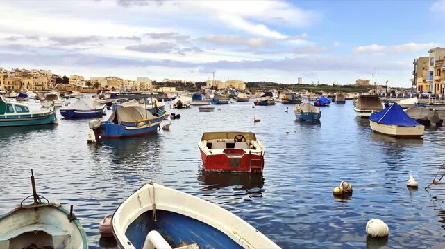 Birzebbuga, Malta &ndash; Mediterranean cityscape with boats in the foreground, mixed architecture and urban everyday life