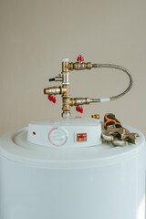 Water heater during fixing on beige background