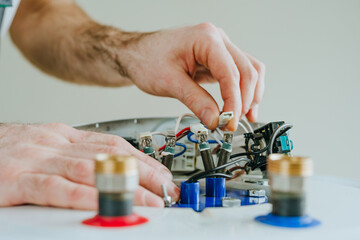 Close-up of master repairing the electricity of the water heater