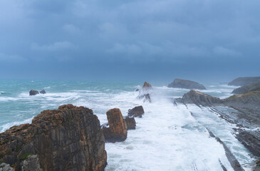 Obraz premium Storm and high waves in the Cantabrian Sea in the Liencres Natural Park within the Costa Quebrada Geopark. Liencres, Cantabria, Spain, Europe