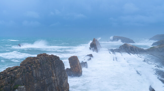 Storm and high waves in the Cantabrian Sea in the Liencres Natural Park within the Costa Quebrada Geopark. Liencres, Cantabria, Spain, Europe