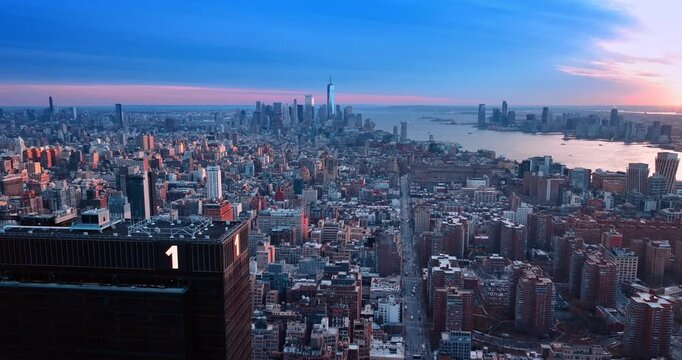 Flight at the top of One Penn Plaza in Manhattan panorama. Vast scenery of New York at sunset.