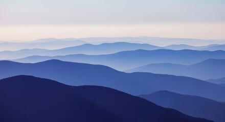 Layered Blue Mountains and Misty Valleys at Sunset
