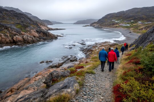 Group hiking coastal trail in greenland arctic landscape