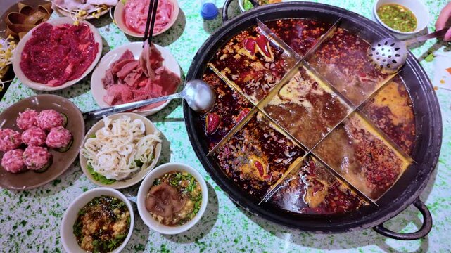 Tourists eating the original spicy dish mala spicy hot pot in Chengdu, China