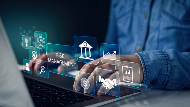 Business person using laptop with risk management strategy interface. Financial analysis concept for corporate investment safety, crisis control plan and business insurance protection system.