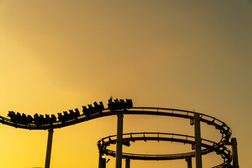 Sunset Silhouette: Roller Coaster Over California Coast