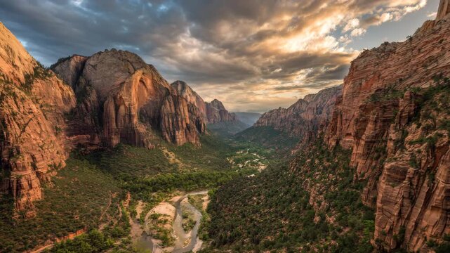 Ultra HD Majestic panoramic view of zion canyon at sunset, featuring towering sandstone cliffs, a winding river, and a lush green valley under a dramatic sky video