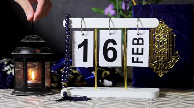 Ramadan February 16 Calendar  Display With Islamic Book, Lantern, and Prayer Beads Arrangement