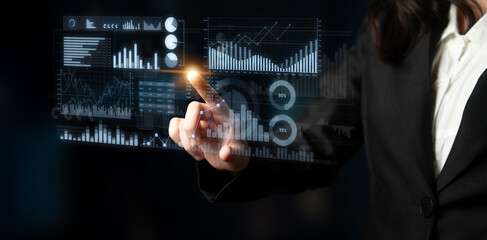 A business professional engages with advanced virtual data displays, showcasing analytics and charts that illustrate key metrics for informed decision-making. Scalp