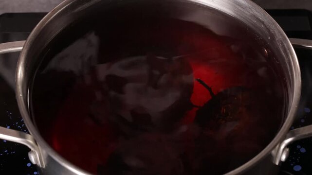 The cook takes the cooked beets out of the pan.