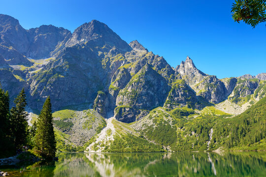 landscape with lake in mountains. scenic nature of poland with rocky peaks in summer. high tatras are wonderful place for travel in eastern europe