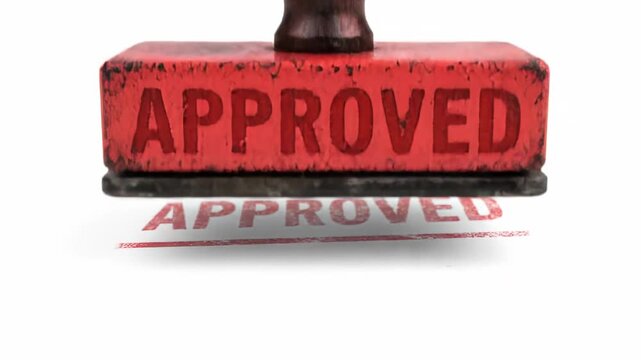 Vintage wooden stamp with the word approved in red ink, ideal for illustrating themes of agreement, approval, and permission on official paperwork