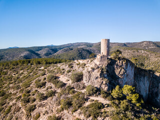 Fototapeta premium The medieval castle El Castellot with a tower in the mountains of Spain, drone photo