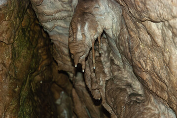 Stalactite and Flowstone Formations Inside Limestone Cave