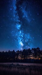 Fototapeta premium A breathtaking night sky panorama showcasing the vibrant blue Milky Way above a dark forest silhouette.