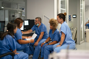 Medical team reviewing data together in a modern hospital setting