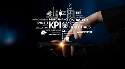 A close-up of a hand using a smartphone, overlaying a cloud of business KPI and performance terms, emphasizing strategy and analytics in a modern digital environment. Tessel