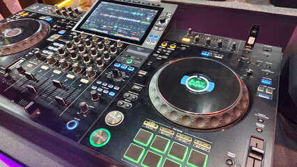 A DJ controller and mixer setup with dual jog wheels