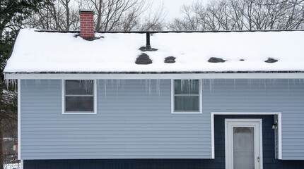 winter house with icicle and snow on the roof