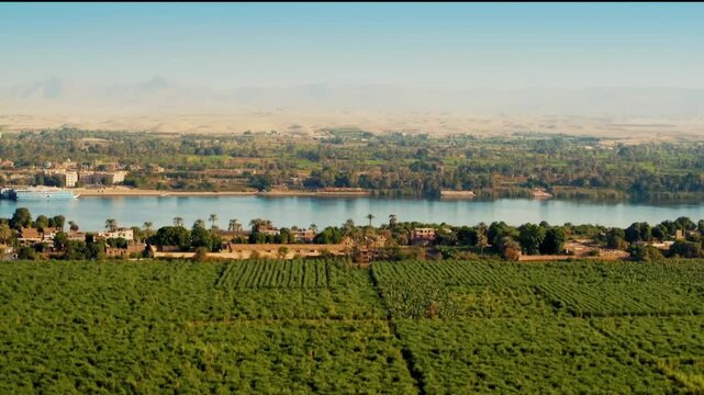 Nile River Valley with Lush Green Fields and Desert Mountains in Egypt Cinematic Aerial View