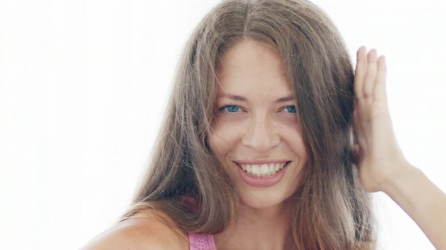 Young adult woman dances zumba in the bright airy room