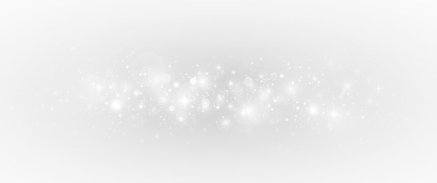 Glowing decoration with sparkling stardust and silver shimmer. Festive background with luxury glitter particles and bright light.
