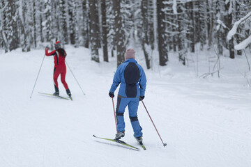 Cross-country skiing in hilly terrain in winter. Outdoor fitness.