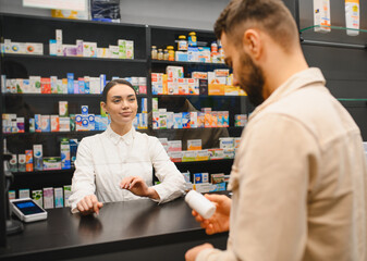 Pharmacist assisting customer at pharmacy counter