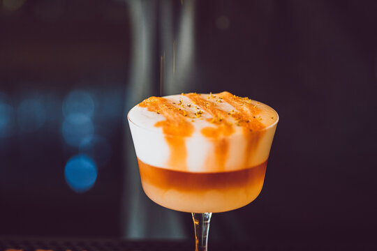 a cocktail in a coup glass at a high end bar and restaurant