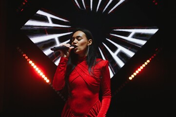 Female music artist performing on concert stage