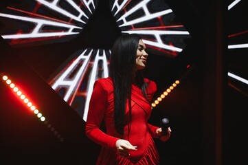Female singer performing live on stage with microphone