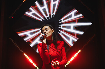 Woman singer performing with microphone on stage
