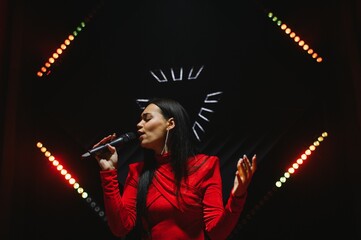 Female singer performing on stage during concert