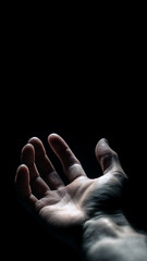 Dramatic Close-Up of Open Human Hand with Outstretched Palm on Black Background, Concept of Help, Protection and Connection, Copy Space, Vertical 9:16