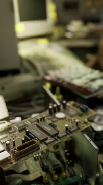 close up circuit board assembly conveyor, blurred reflow oven in background, solder joints and microchips in sharp focus, industrial lighting creating warm