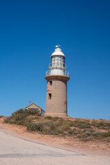 Scenic perspective of Ningaloo coastline with Vlamingh Head lighthouse perched on rocky cliffs
