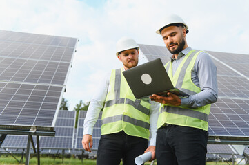 Engineers discuss renewable energy project with solar panels