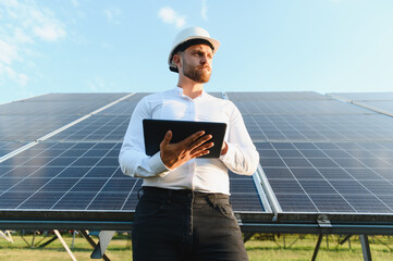 Engineer checking solar panels for green energy production