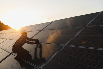 Worker installing solar panels practicing sustainable energy