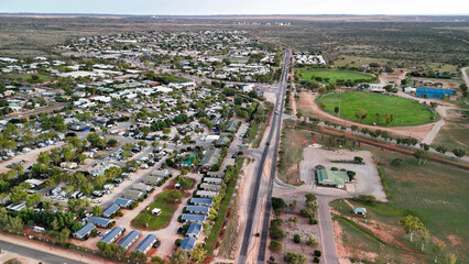 Fototapeta premium Birds eye perspective showcasing Exmouth neighborhood houses coastal township harbor turquoise ocean backdrop Australia
