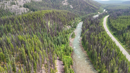 Jasper aerial cityscape with Athabasca River surrounded by mountains and green summer scenery