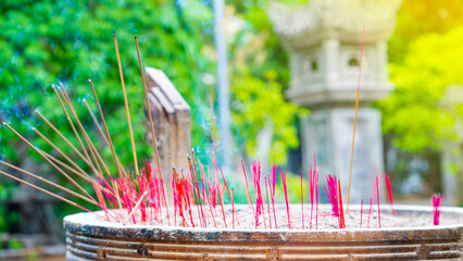 Smoking incense sticks, close-up. Burning incense sticks in the temple of Asia. Long Son Pagoda in Nha Trang, Vietnam.
