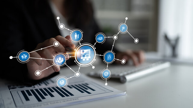 A business professional in an office setting interacts with a digital technology interface featuring data visualization tools, showcasing modern communication and analysis strategies. Tessel