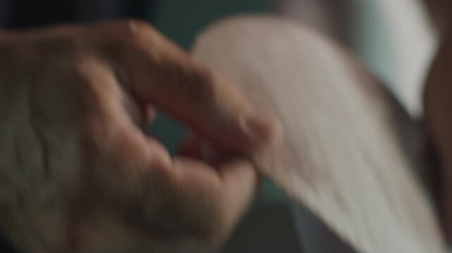 Surf factory. Adult male shaper creates the surfing board on the factory