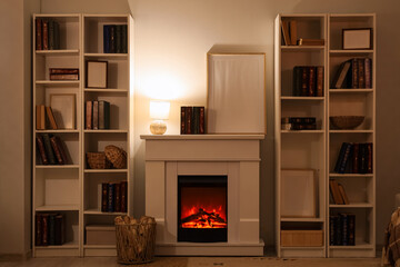 Naklejka premium Interior of stylish room with fireplace and bookshelves at evening