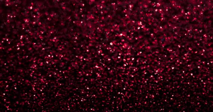 Dense red heart glitter confetti sparkles on a dark backdrop in stop-motion style. Romantic abstract texture for Valentine&rsquo;s Day, love promos, festive overlays, and seamless loops.
