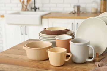 Clean dishes on wooden table in kitchen